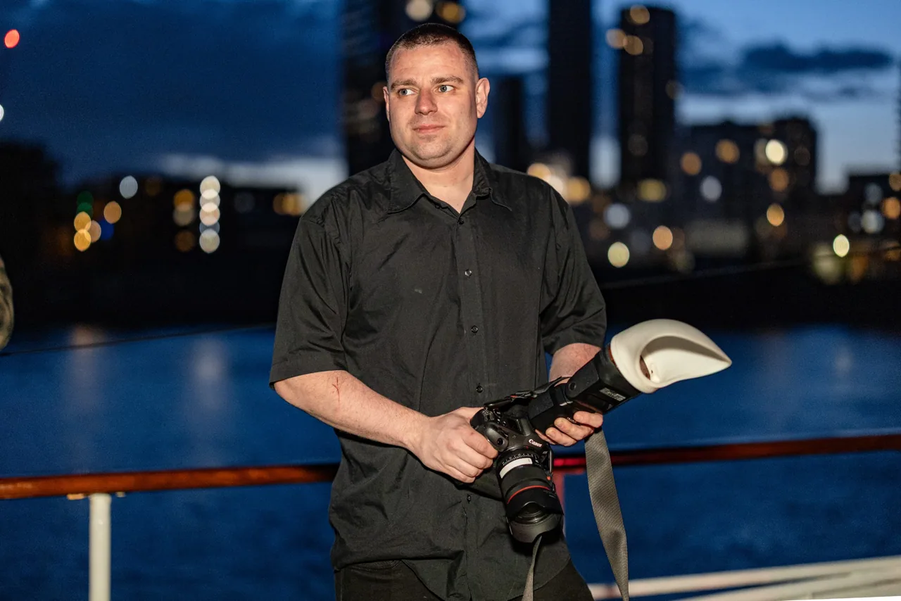 Charles Hoggarth holding his camera and flash.